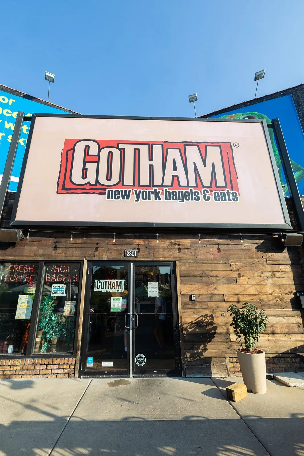 The Gotham New York Bagels and Eats storefront and sign on a sunny morning