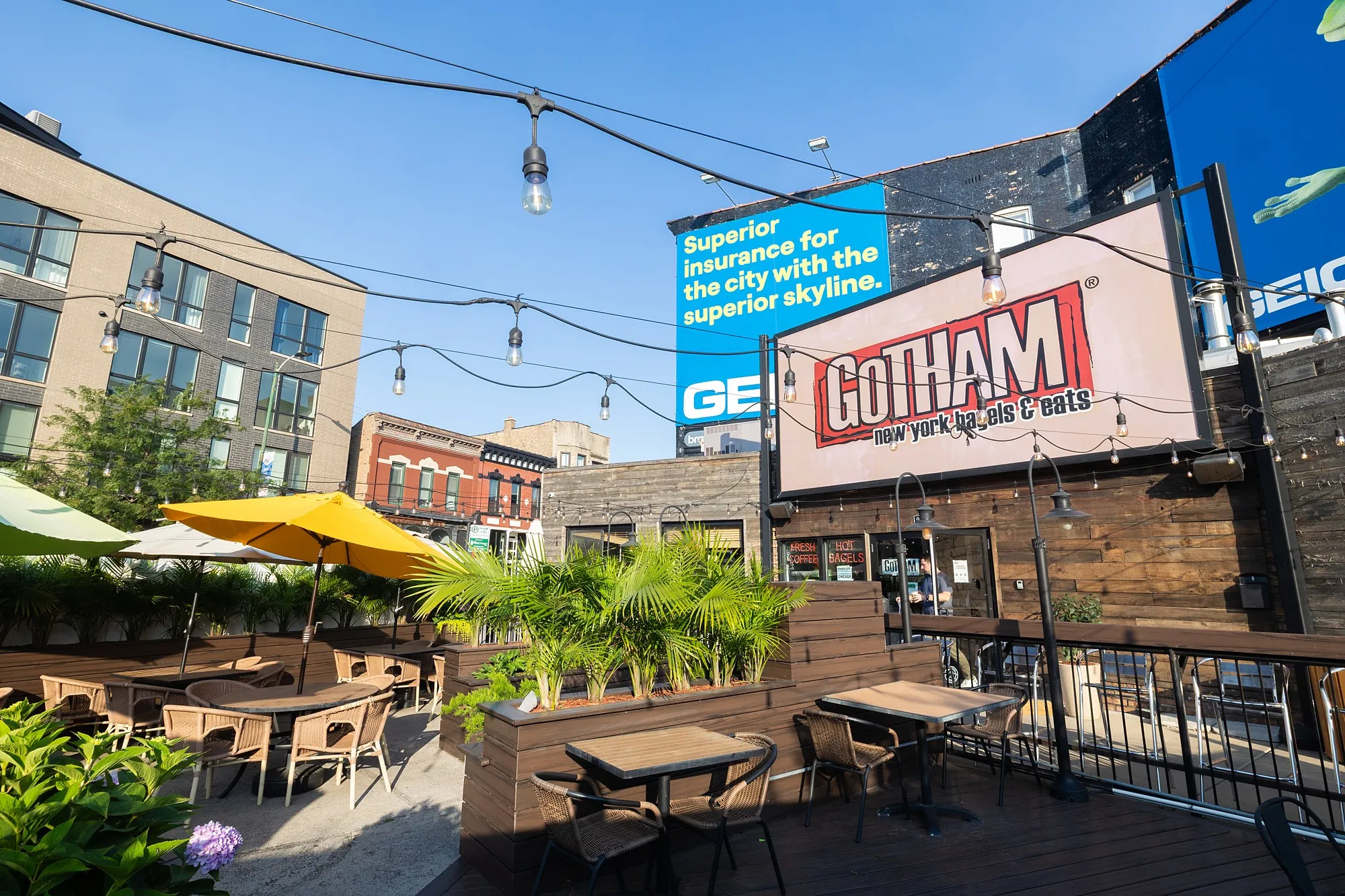 The patio outside Gotham Bagels Lakeview under the Gotham sign