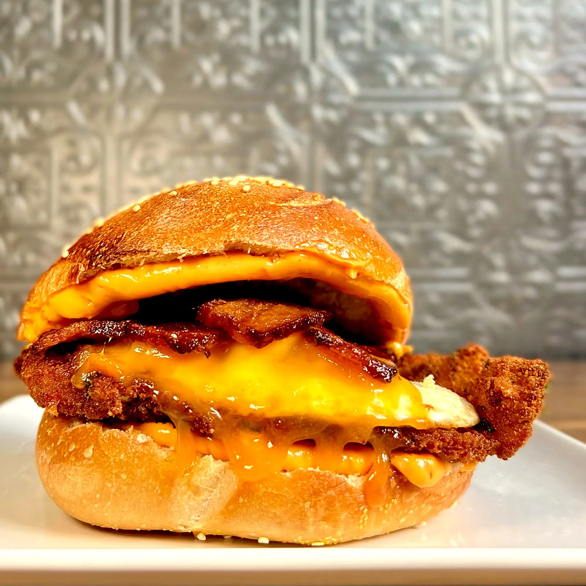 The OMFG: fried chicken, bacon, a fried egg and melted cheddar stacked on a sesame bagel