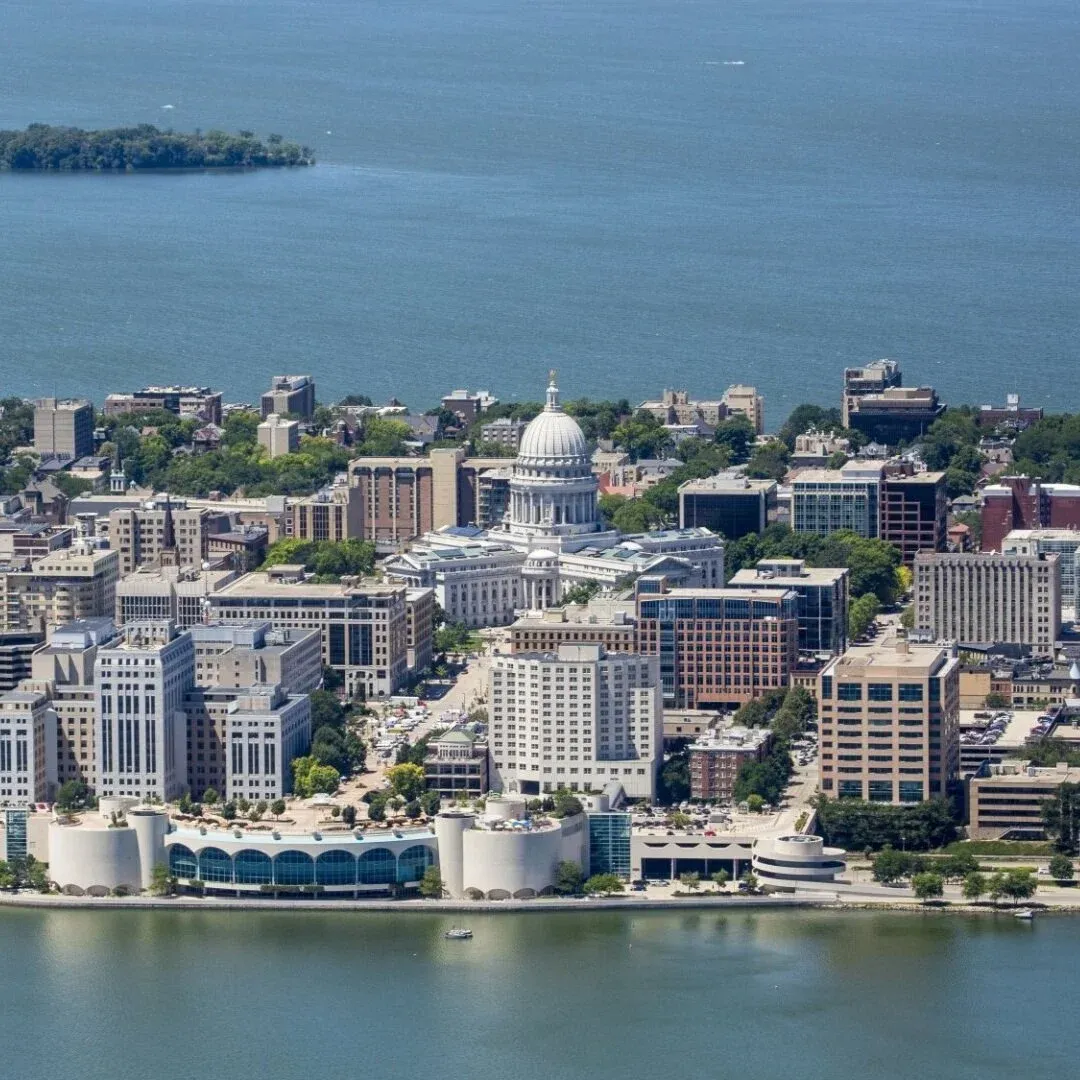 Aerial view of downtown Madison with the white-domed Wisconsin State Capitol between two lakes